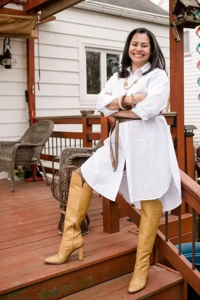 Vida DeOlivier wearing a white shirt dress and yellow boots.